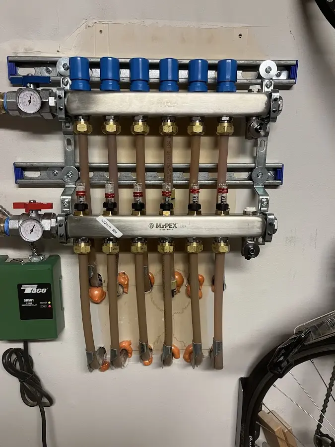 Plumber performing Water Heater Repair at a residential property in Menallen